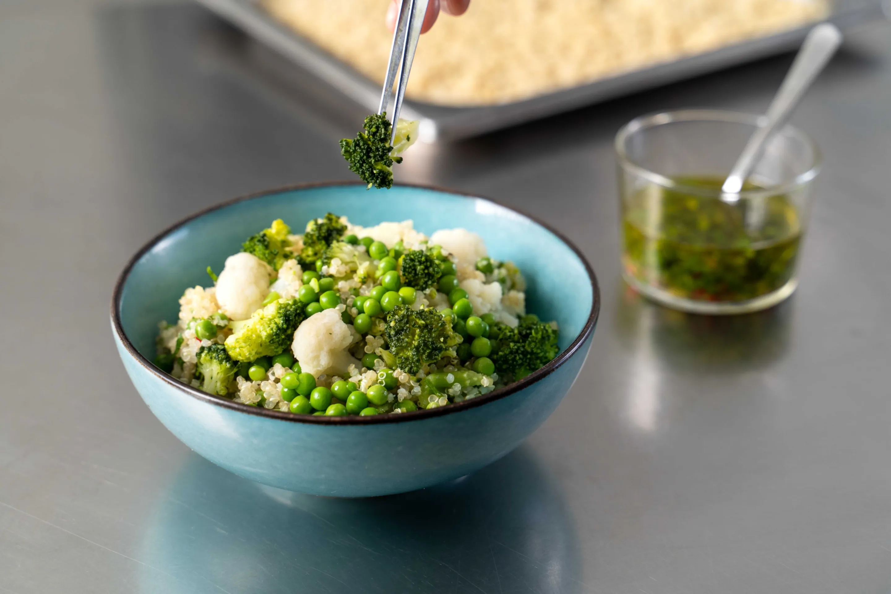 Bowl di quinoa, con piselli, cavoli misti marinati con prezzemolo, limone e peperoncino /